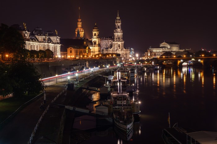 Dresden skyline at night with Elbe river and boats