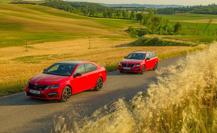 Two red Skoda Octavia cars on a road