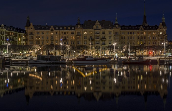 Stockholm waterfront at night with boats and buildings