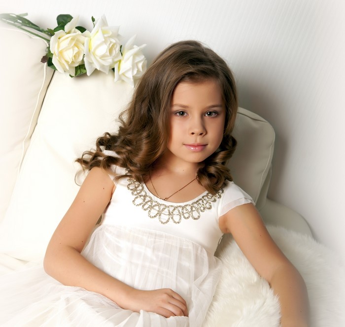 Young girl in a white dress with roses