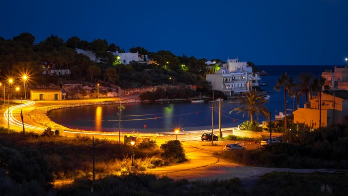 Night view of Porto Petro cove with street lights and houses