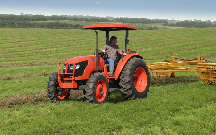 Kubota M7040 Tractor with Hay Rake in Field