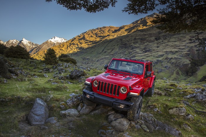 Red Jeep Wrangler Rubicon off-roading in mountains