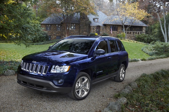 Blue 2011 Jeep Compass parked on gravel driveway