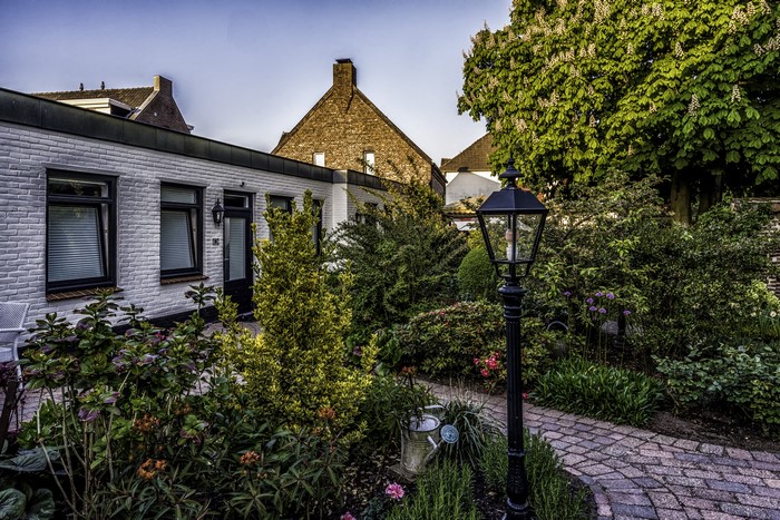 Houses and garden with street light in Arcen Limburg, Netherlands