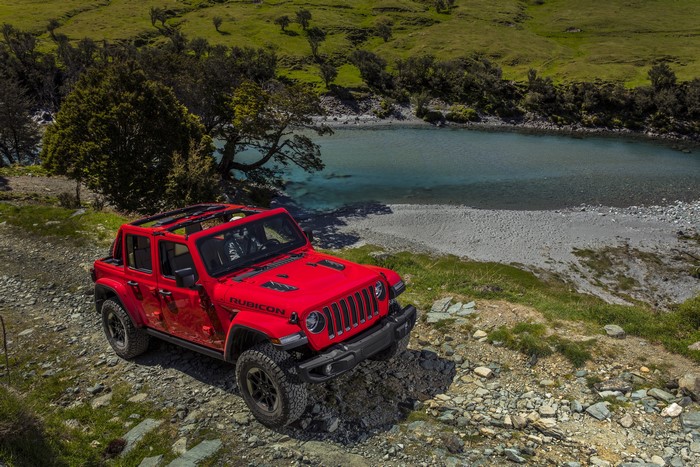 Red Jeep Wrangler Rubicon by a river