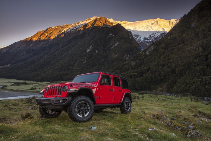Red Jeep Wrangler Unlimited Rubicon in Mountains