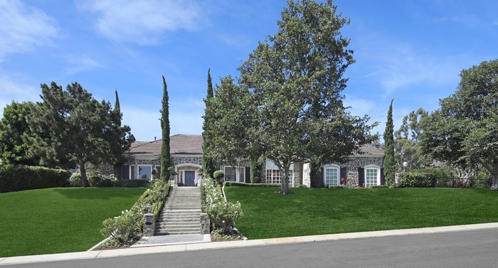 Stone Mansion with Large Lawn and Stairs