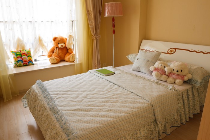 Children's room with teddy bear and bed