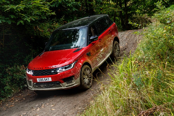 Red Land Rover Sport Autobiography driving off-road