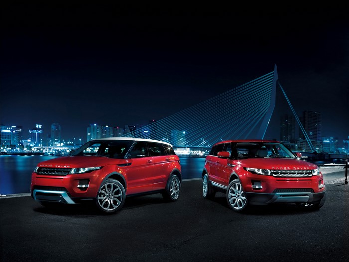 Two red Range Rover Evoque cars at night