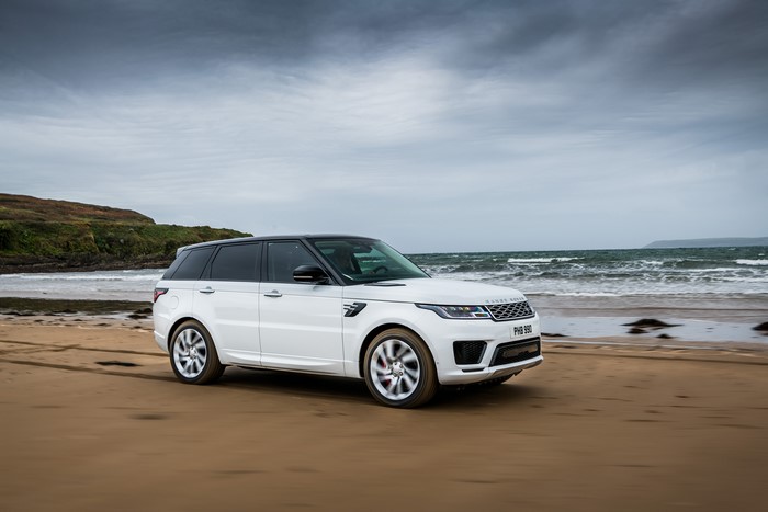 White Land Rover Sport P400e Autobiography on a beach
