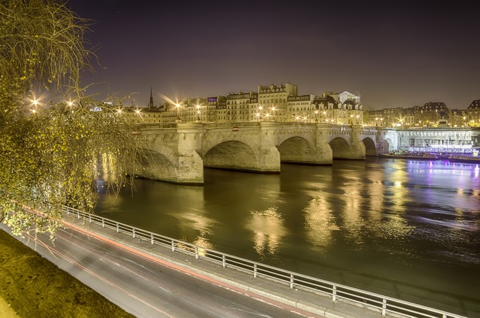 Parisian bridge over the Seine River at night