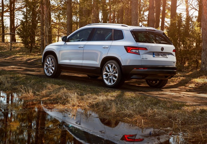 White Skoda Karoq Crossover parked by a forest lake