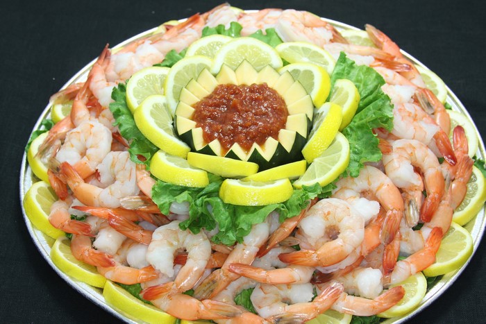 Shrimp platter with lemons and cocktail sauce