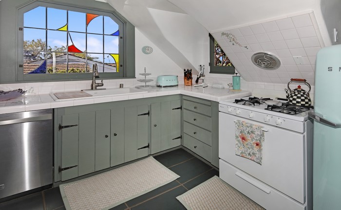 Kitchen with stained glass window and retro refrigerator