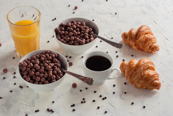 Breakfast with Coffee, Juice, Croissants, and Cereal