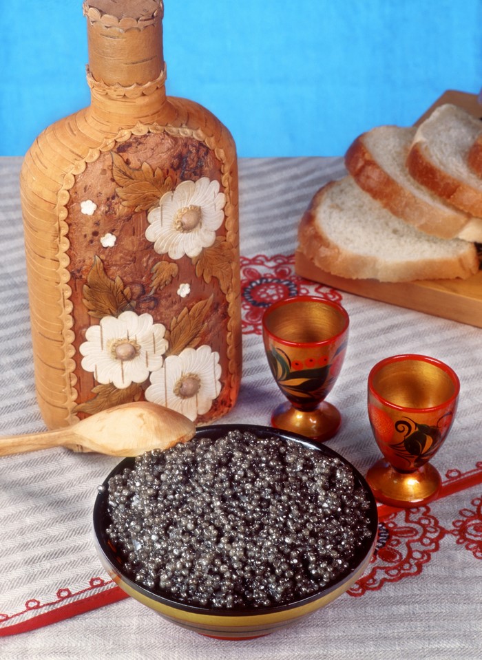 Caviar with bread, vodka bottle, and shot glasses