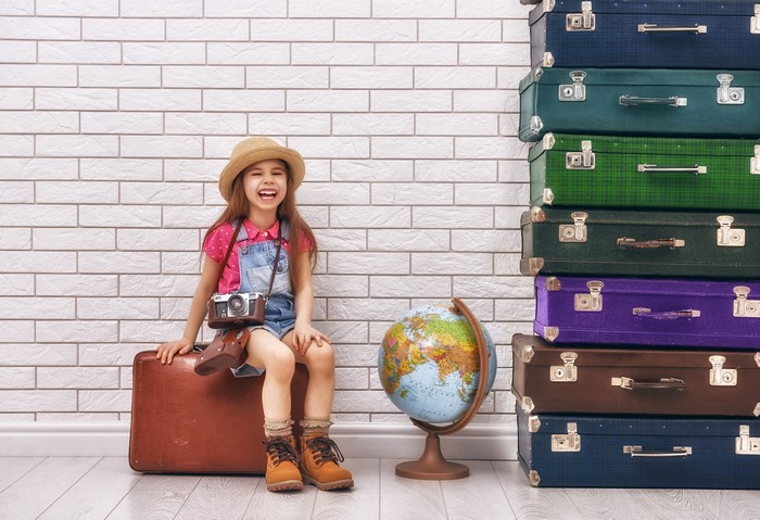 Girl with camera and suitcases