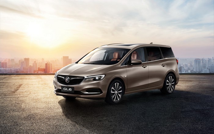 Buick GL6 MPV on rooftop with city skyline