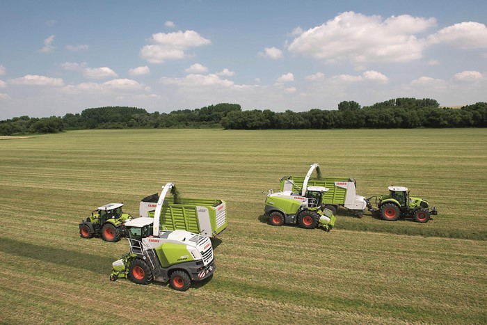 Claas agricultural machinery harvesting a field