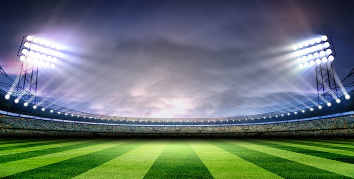Soccer stadium with bright lights and green field