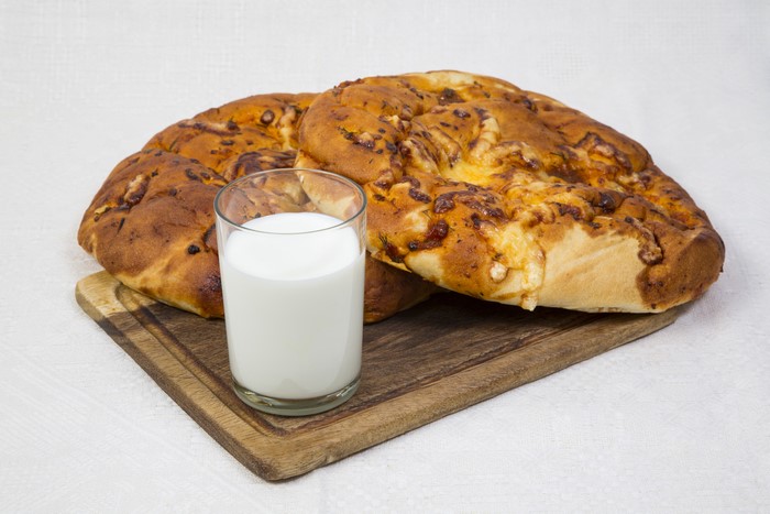 Pastry buns with milk on a cutting board