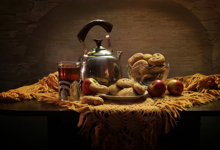 Still life with kettle, tea, apples, and pastries