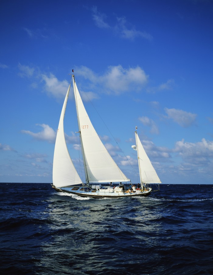 Sailboat sailing on the ocean under a blue sky