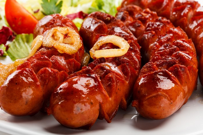 Grilled sausages with onions and salad