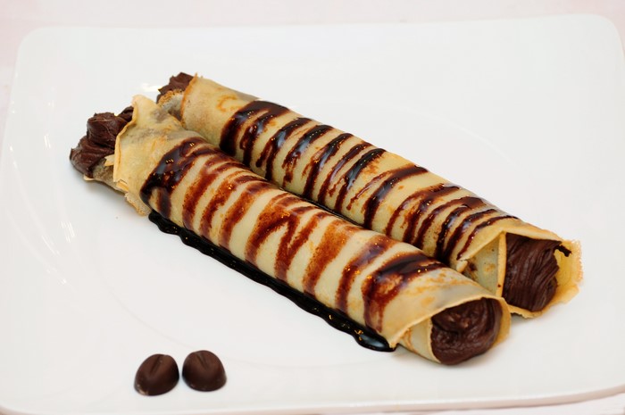 Two chocolate crepes with chocolate drizzle