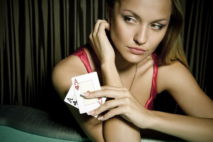Woman holding two Aces cards