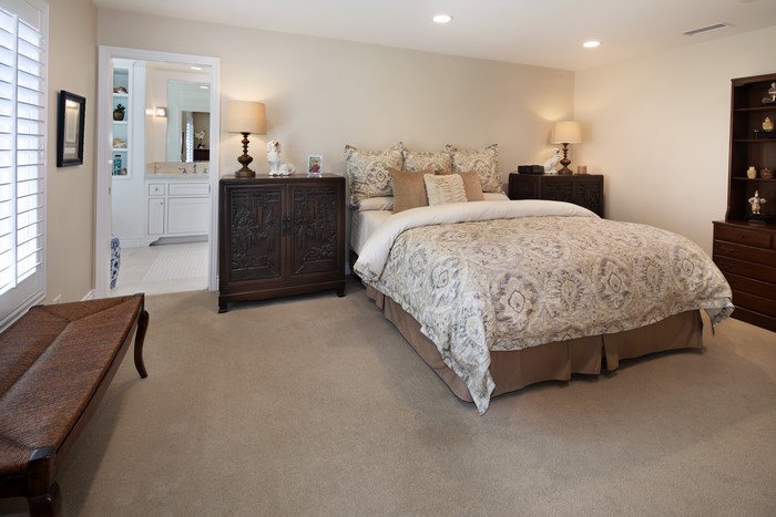 Bedroom with bed, lamps, and dresser
