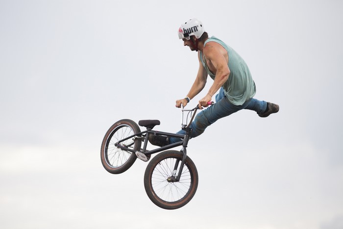 BMX rider performing a jump with a helmet