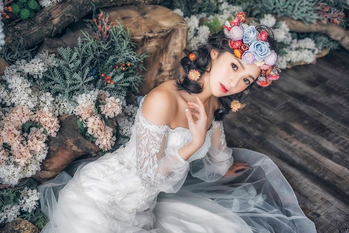 Asian bride with flower wreath in white dress