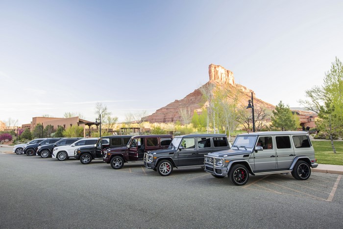 Mercedes-Benz G-Wagon SUVs parked in a row with a mountain in the background