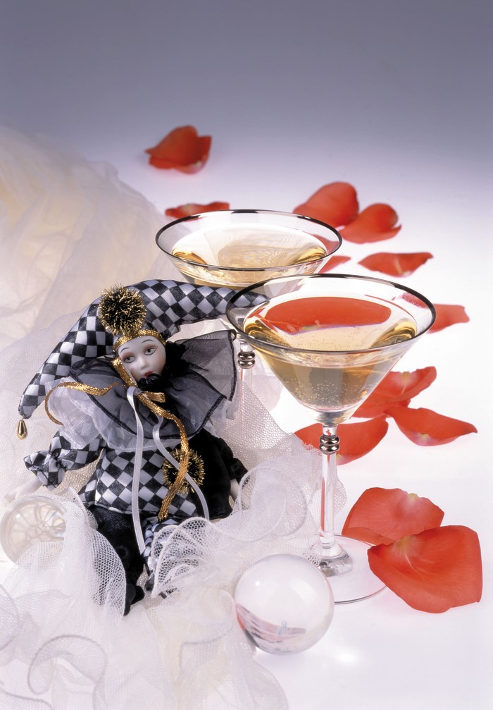 Clown doll with champagne and rose petals