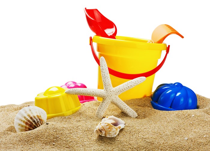 Beach toys and shells on sand