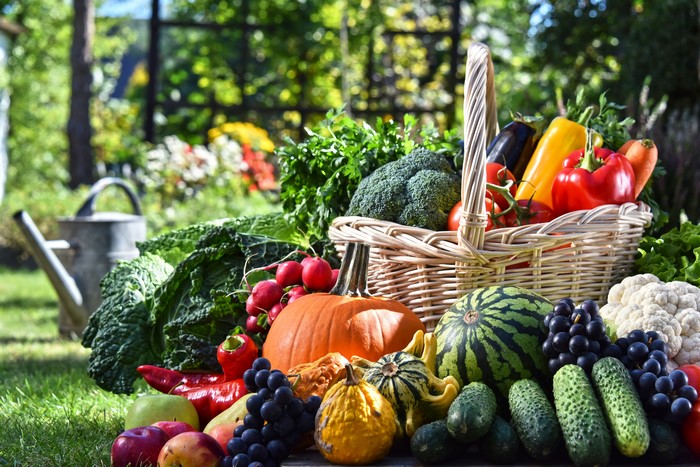 Assortment of Fresh Fruits and Vegetables in a Wicker Basket