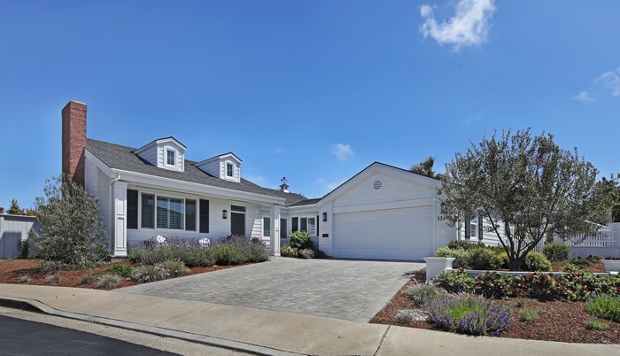 White house with brick chimney and garage in Dana Point, USA