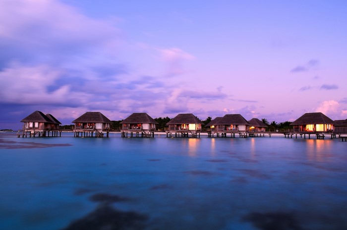 Overwater bungalows in the Maldives at sunset