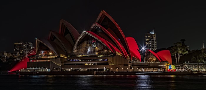 Sydney Opera House illuminated in red at night