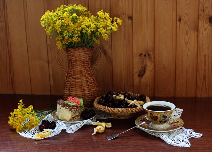 Still life with cake, cherries, coffee, and flowers