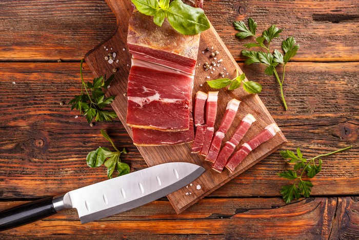 Ham on a cutting board with a knife