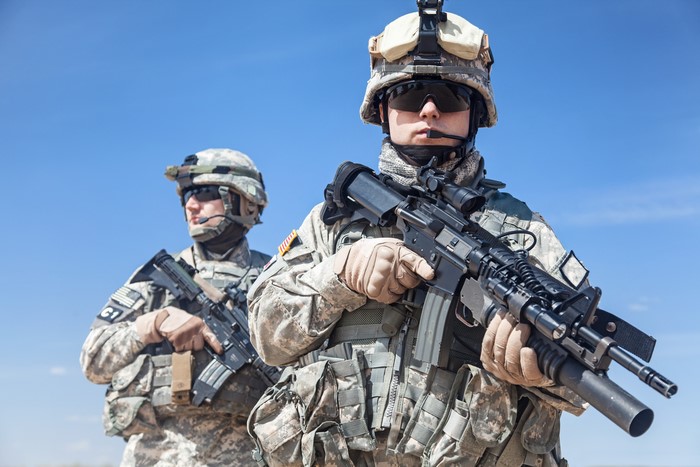 Two American soldiers with assault rifles