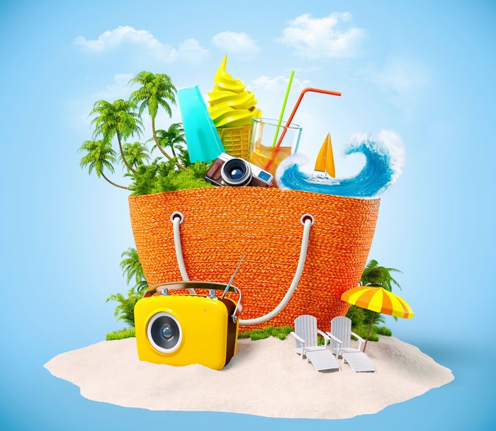Summer beach vacation items in a woven bag