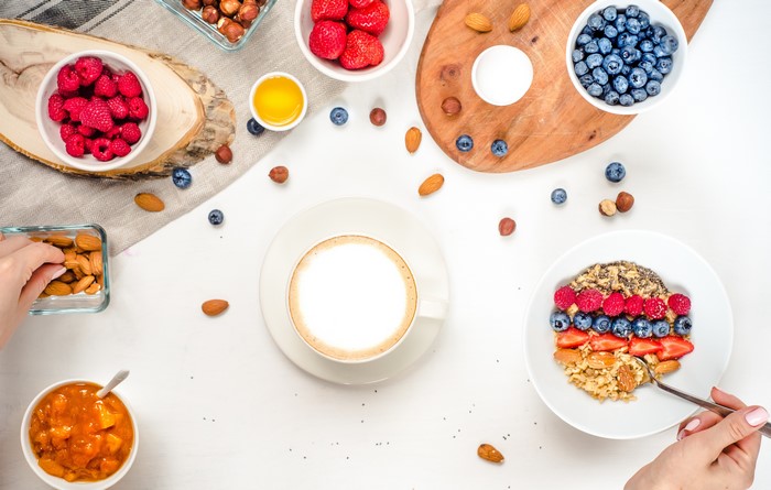 Breakfast with Muesli, Berries, Nuts, and Cappuccino