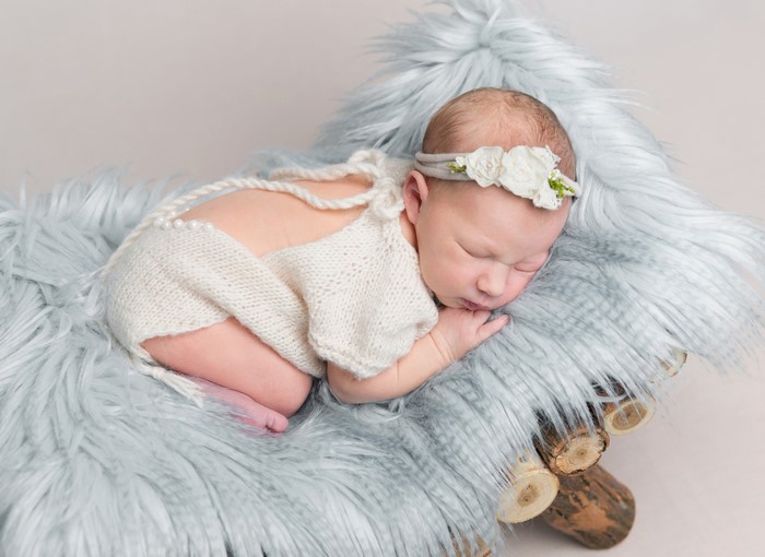Newborn baby sleeping on blue fur