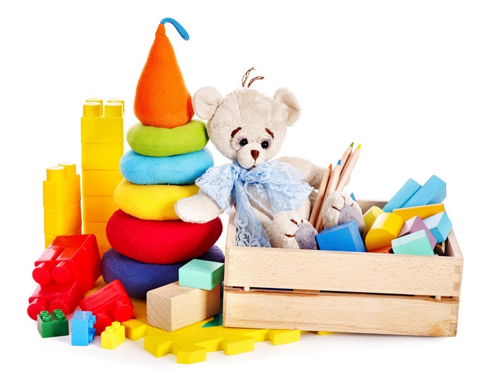 Toys: Teddy bear, stacking rings, building blocks, and crayons
