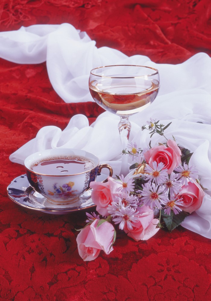 Still-life with tea cup, wine glass, and flowers